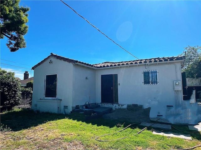 1803 S Charlotte Ave, San Gabriel, CA 91776 - rear view of house featuring a tiled roof, a lawn, and stucco siding