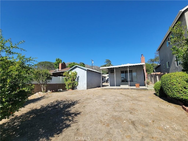 10563 Las Lunitas Ave, Tujunga, CA 91042 - rear view of house featuring a fenced backyard, a chimney, a patio, and stucco siding