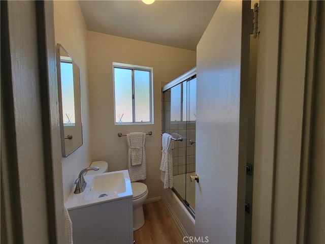 10563 Las Lunitas Ave, Tujunga, CA 91042 - full bathroom featuring healthy amount of natural light, wood finished floors, vanity, and shower / bath combination with glass door