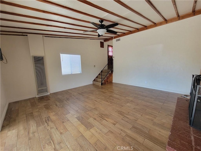 10563 Las Lunitas Ave, Tujunga, CA 91042 - unfurnished room featuring a heating unit, a ceiling fan, light wood-style floors, stairway, and beam ceiling