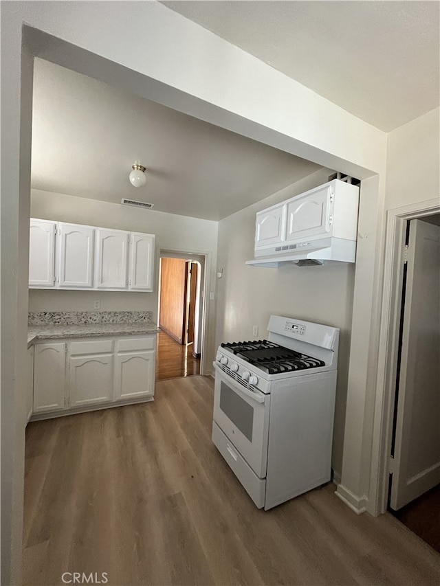 10563 Las Lunitas Ave, Tujunga, CA 91042 - kitchen with gas range gas stove, white cabinets, wood finished floors, and premium range hood