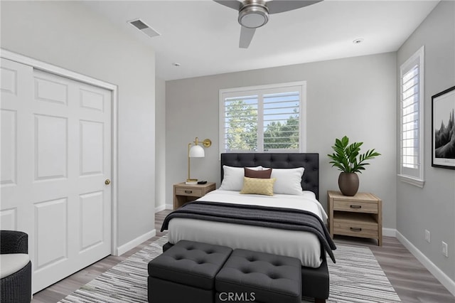 23825 Lancer Ct, Wildomar, CA 92595 - bedroom featuring multiple windows, wood finished floors, and ceiling fan