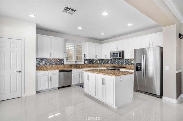 23825 Lancer Ct, Wildomar, CA 92595 - kitchen featuring appliances with stainless steel finishes, decorative backsplash, dark stone countertops, white cabinetry, and recessed lighting