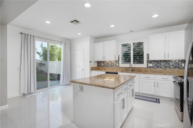 23825 Lancer Ct, Wildomar, CA 92595 - kitchen featuring a kitchen island, recessed lighting, light stone counters, backsplash, and white cabinetry