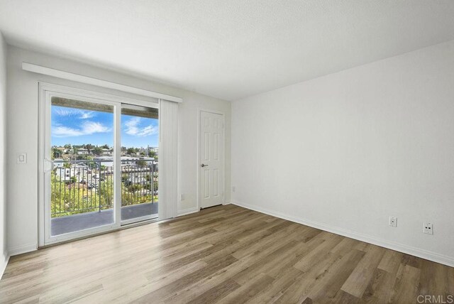 5252 Orange Ave Unit 326, San Diego, CA 92115 - unfurnished room with wood finished floors and baseboards