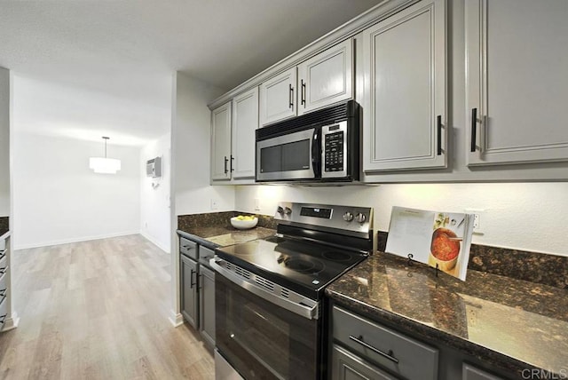 5252 Orange Ave Unit 326, San Diego, CA 92115 - kitchen with appliances with stainless steel finishes, gray cabinetry, light wood-style floors, and dark stone counters