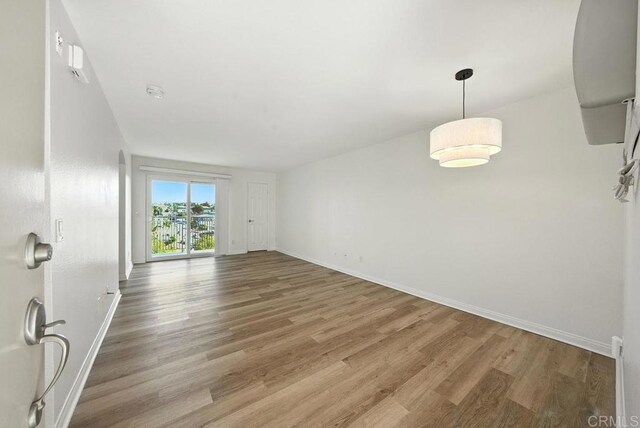 5252 Orange Ave Unit 326, San Diego, CA 92115 - unfurnished living room featuring wood finished floors and baseboards