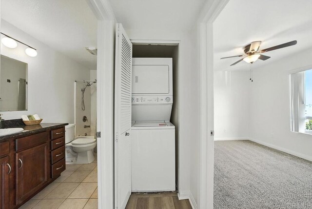 5252 Orange Ave Unit 326, San Diego, CA 92115 - bathroom with stacked washer and clothes dryer, vanity, ceiling fan, and washtub / shower combination