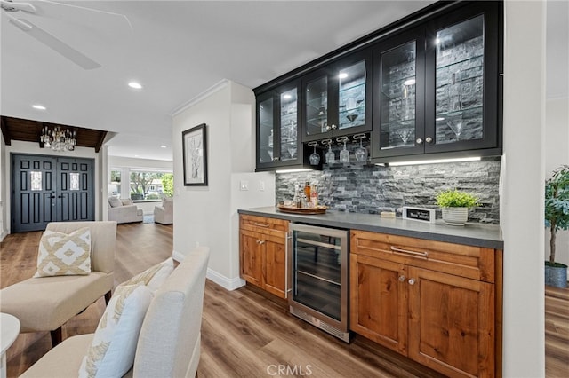 2777 Shadow Canyon Cir, Norco, CA 92860 - indoor dry bar with beverage cooler, dark wood-style floors, decorative backsplash, recessed lighting, and a chandelier