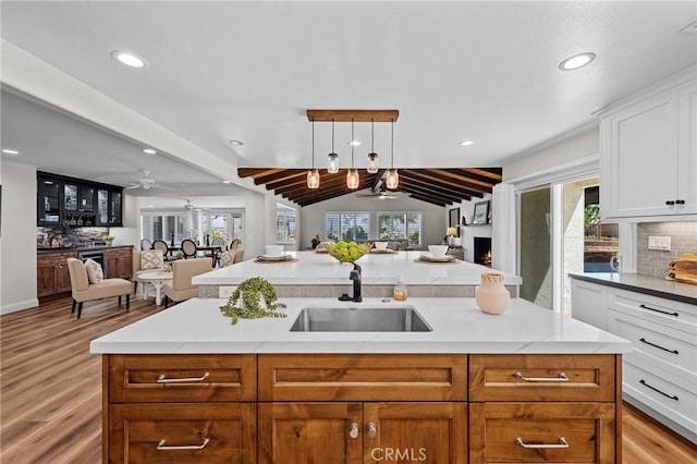 2777 Shadow Canyon Cir, Norco, CA 92860 - kitchen with open floor plan, ceiling fan, light wood-style floors, backsplash, and lofted ceiling