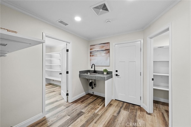 2777 Shadow Canyon Cir, Norco, CA 92860 - laundry area featuring ornamental molding, wood finished floors, and recessed lighting