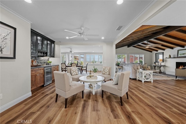2777 Shadow Canyon Cir, Norco, CA 92860 - living area with beverage cooler, a dry bar, recessed lighting, wood finished floors, and a warm lit fireplace