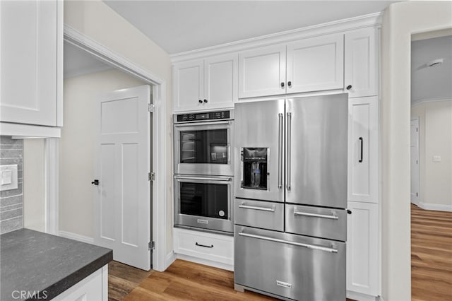 2777 Shadow Canyon Cir, Norco, CA 92860 - kitchen featuring stainless steel appliances, wood finished floors, and white cabinetry