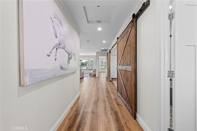 2777 Shadow Canyon Cir, Norco, CA 92860 - corridor featuring a barn door, light wood-style floors, and recessed lighting
