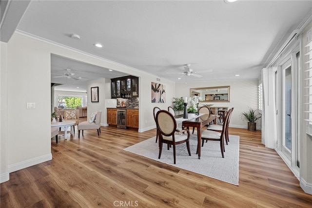 2777 Shadow Canyon Cir, Norco, CA 92860 - dining space with wine cooler, a ceiling fan, a dry bar, light wood-style flooring, and recessed lighting