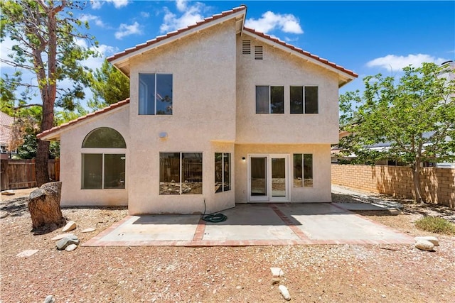 39524 Hawthorne St, Palmdale, CA 93551 - back of property with stucco siding, a fenced backyard, a patio, and a tiled roof