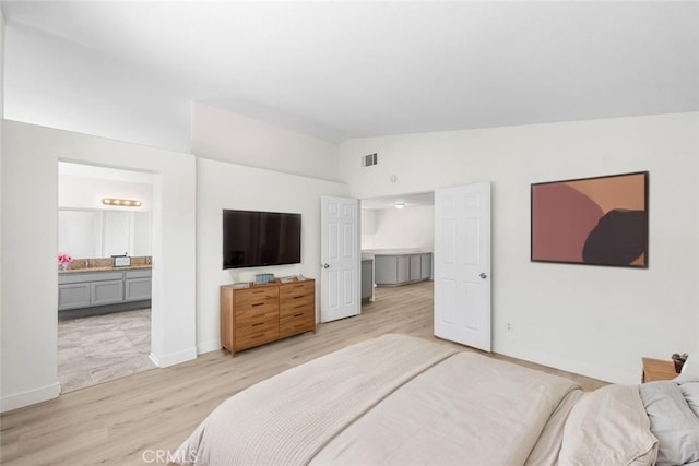39524 Hawthorne St, Palmdale, CA 93551 - bedroom with vaulted ceiling, light wood finished floors, and connected bathroom