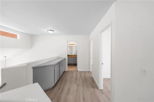 39524 Hawthorne St, Palmdale, CA 93551 - corridor featuring light wood-style floors and an upstairs landing