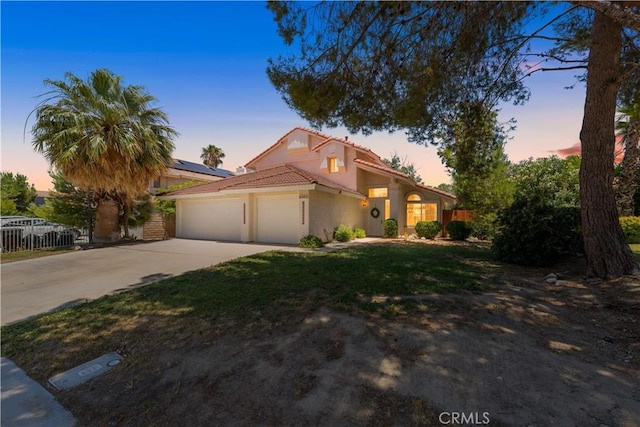 39524 Hawthorne St, Palmdale, CA 93551 - mediterranean / spanish home with an attached garage, driveway, a tiled roof, and stucco siding