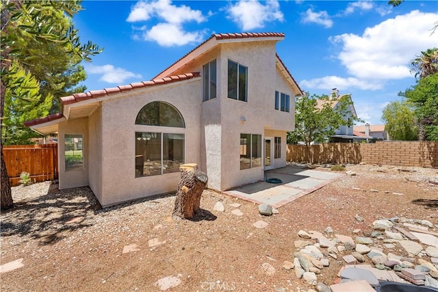 39524 Hawthorne St, Palmdale, CA 93551 - rear view of property with stucco siding, a tiled roof, and a patio area