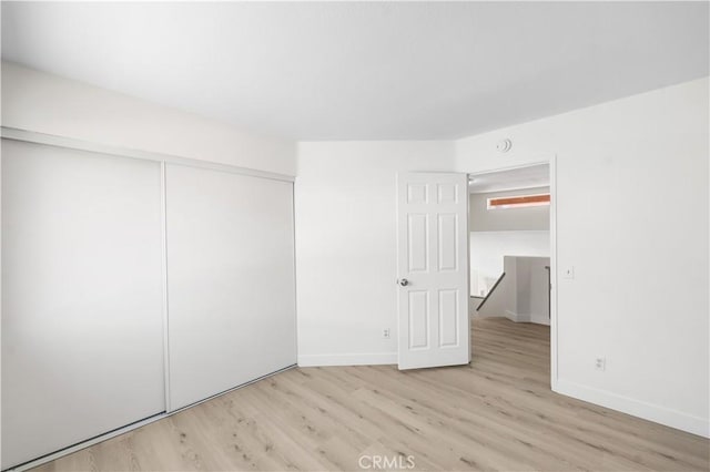 39524 Hawthorne St, Palmdale, CA 93551 - unfurnished bedroom with light wood finished floors and a closet