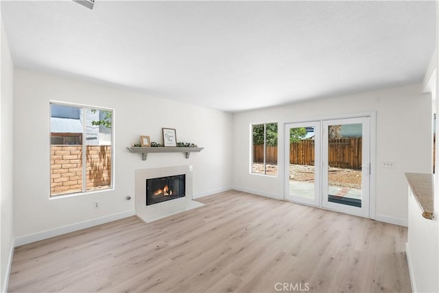39524 Hawthorne St, Palmdale, CA 93551 - unfurnished living room featuring light wood-style flooring and a fireplace with flush hearth