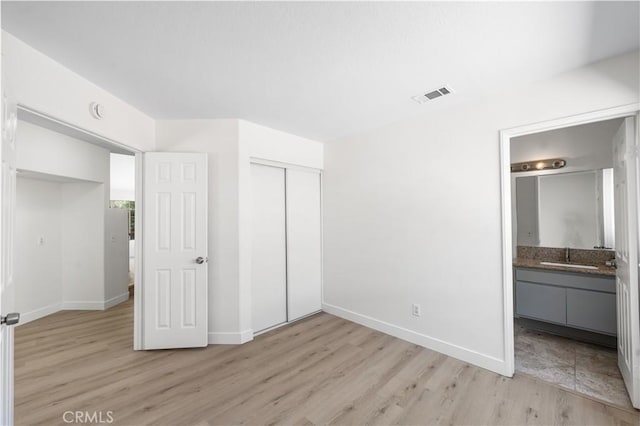 39524 Hawthorne St, Palmdale, CA 93551 - unfurnished bedroom with light wood-style floors, a closet, and connected bathroom