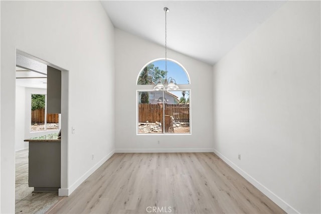 39524 Hawthorne St, Palmdale, CA 93551 - unfurnished dining area with a chandelier, wood finished floors, and high vaulted ceiling