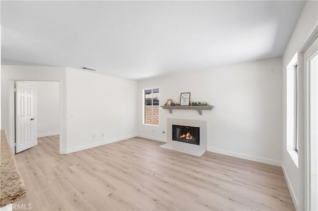 39524 Hawthorne St, Palmdale, CA 93551 - unfurnished living room with light wood-style floors and a fireplace with flush hearth