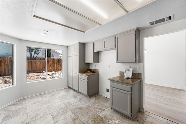 39524 Hawthorne St, Palmdale, CA 93551 - kitchen featuring gray cabinets, a textured ceiling, and dark countertops