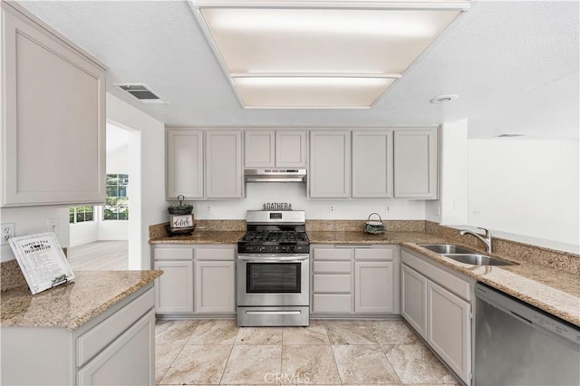 39524 Hawthorne St, Palmdale, CA 93551 - kitchen featuring stainless steel appliances, under cabinet range hood, and light stone countertops