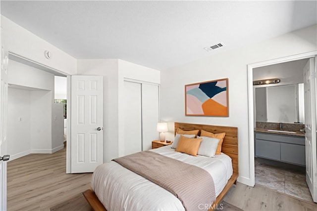 39524 Hawthorne St, Palmdale, CA 93551 - bedroom with a closet, ensuite bathroom, and light wood-style floors