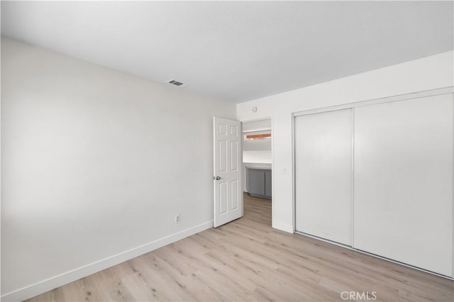 39524 Hawthorne St, Palmdale, CA 93551 - unfurnished bedroom with light wood-type flooring and a closet