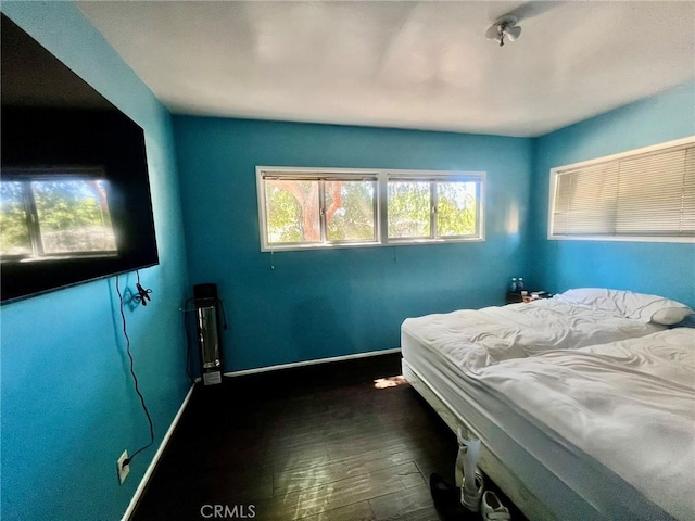 14712 Hiawatha St, San Fernando, CA 91345 - bedroom featuring baseboards and dark wood-style flooring