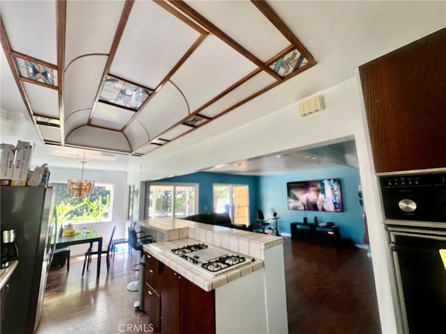 14712 Hiawatha St, San Fernando, CA 91345 - kitchen featuring tile counters, freestanding refrigerator, white gas cooktop, a chandelier, and oven