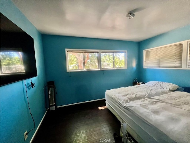 14712 Hiawatha St, San Fernando, CA 91345 - bedroom featuring dark wood-type flooring and baseboards