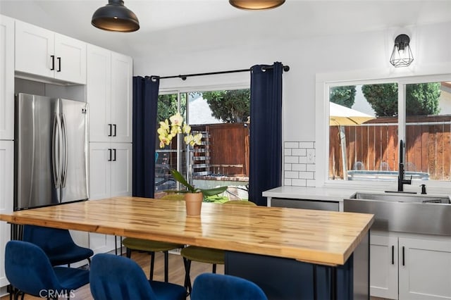 7 Via Olorosa, Rancho Santa Margarita, CA 92688 - kitchen with wooden counters, white cabinets, and freestanding refrigerator