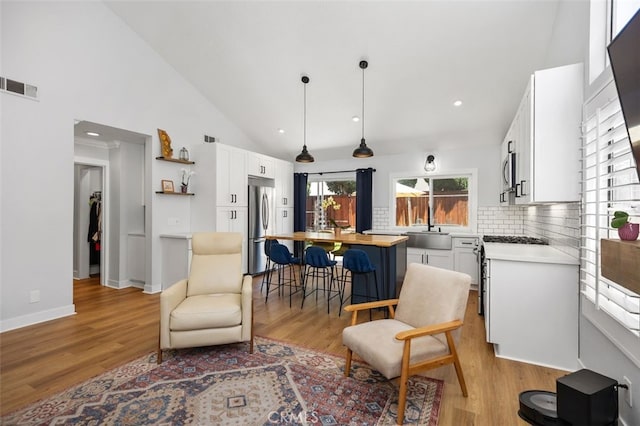 7 Via Olorosa, Rancho Santa Margarita, CA 92688 - living room featuring light wood finished floors, recessed lighting, and high vaulted ceiling
