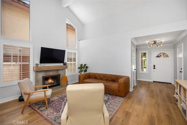 7 Via Olorosa, Rancho Santa Margarita, CA 92688 - living room with wood finished floors, a chandelier, a tile fireplace, crown molding, and a high ceiling