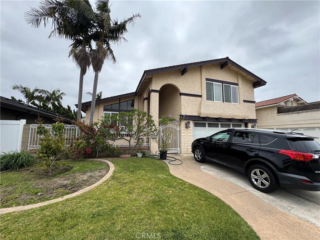 14212 Enfield Cir, Westminster, CA 92683 - view of front of home featuring stucco siding, concrete driveway, a gate, and an attached garage