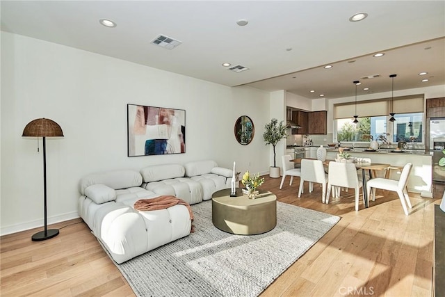 1050 N Joels Pl, Los Angeles, CA 90012 - living room featuring light wood-style floors and recessed lighting