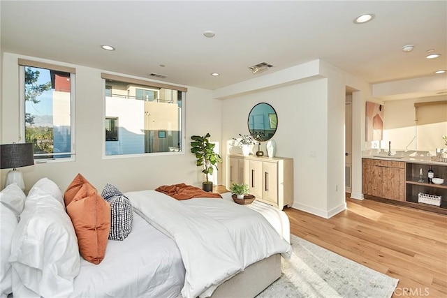 1050 N Joels Pl, Los Angeles, CA 90012 - bedroom with light wood-style floors, recessed lighting, and connected bathroom