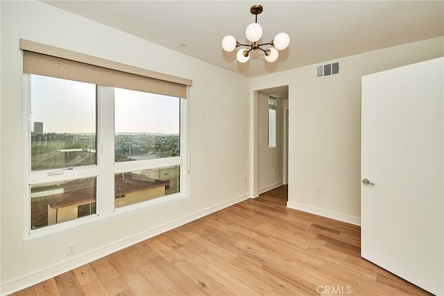 1050 N Joels Pl, Los Angeles, CA 90012 - empty room featuring a chandelier and light wood-type flooring