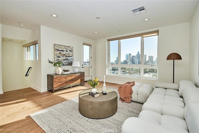 1050 N Joels Pl, Los Angeles, CA 90012 - living area featuring plenty of natural light, light wood-type flooring, a view of skyline, and recessed lighting