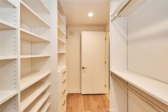 1050 N Joels Pl, Los Angeles, CA 90012 - walk in closet with light wood-type flooring