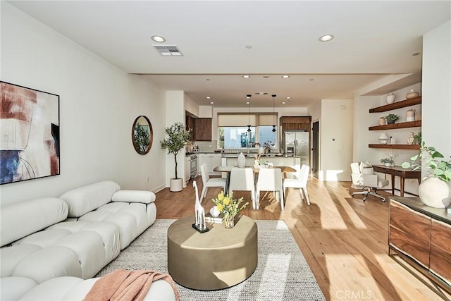 1050 N Joels Pl, Los Angeles, CA 90012 - living room featuring light wood finished floors and recessed lighting