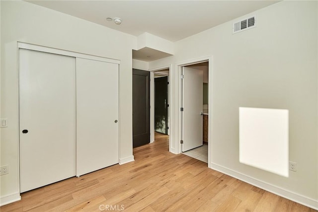 1050 N Joels Pl, Los Angeles, CA 90012 - unfurnished bedroom with light wood-style flooring and a closet