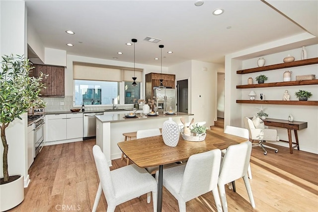 1050 N Joels Pl, Los Angeles, CA 90012 - dining area with light wood-style floors and recessed lighting