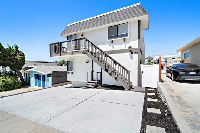 33771 Copper Lantern St, Dana Point, CA 92629 - rear view of house with stucco siding, stairway, and a shingled roof