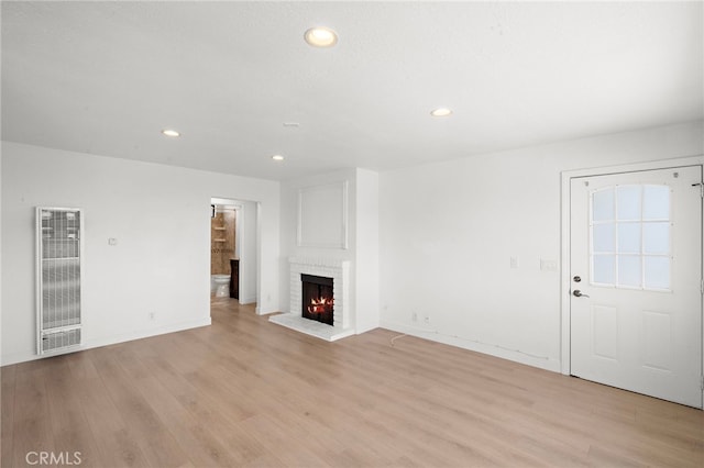 33771 Copper Lantern St, Dana Point, CA 92629 - unfurnished living room with a heating unit, a brick fireplace, light wood finished floors, and recessed lighting